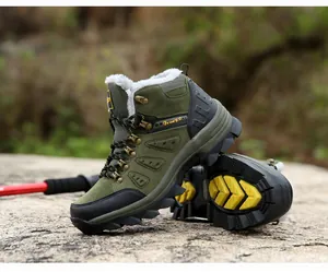 Close-up of olive green outdoor boots showing warm faux fur lining and anti-slip soles