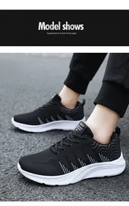 Detail of breathable black mesh running sneakers with white contrast soles for men