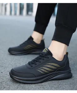 Tragefoto schwarzer Leder-Sneaker mit goldenen Streifen und dicker Sportsohle