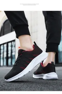 Detail of lightweight white EVA foam sole on black and red breathable mesh running shoes