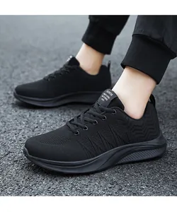 On-foot shot of breathable black sneakers featuring textured mesh and thick non-slip soles