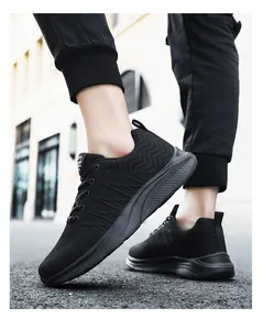Close-up of black breathable mesh running shoes for men with thick cushioned foam soles