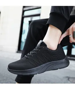 Close-up of black breathable mesh sneakers with wavy texture and cushioned midsole