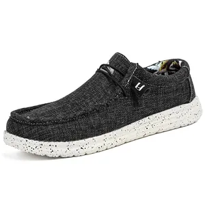 Donkergrijze canvas herenloafers met elastische veters en een witte gespikkelde rubberen zool