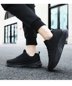 Close-up of black breathable knit upper with dynamic wave patterns on men's sneakers