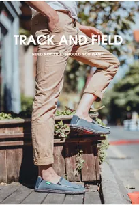 Outdoor shot of denim blue canvas loafers for men with casual frayed edges and slip-on design