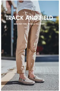 Street style view of men beige canvas loafers paired with khaki casual rolled-up trousers