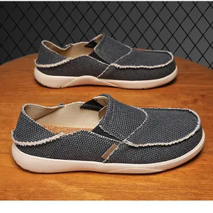 Detail of breathable grey canvas slip-on shoes with raw edges and elastic bands