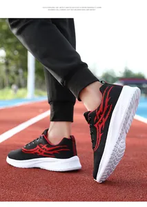 Dynamic side view of men's breathable running shoes with red flame patterns on a track