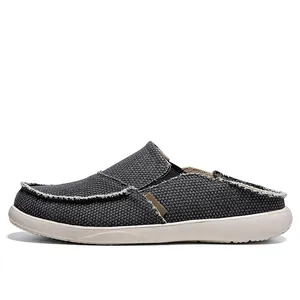 Grey canvas loafers for men with frayed edges and thick cream soles in a side view