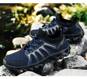 Detail of breathable mesh hiking shoe with non-slip rubber sole on natural river rocks