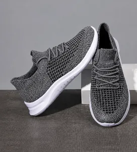 Detailed macro view of breathable grey flyknit fabric on men's lightweight running shoes