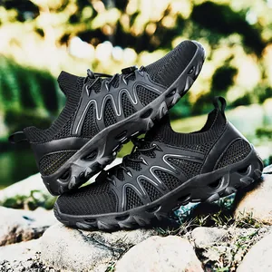 Men's breathable mesh outdoor hiking shoes with durable rubber soles on natural rocks