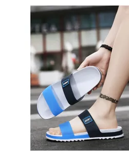Detail of blue and black dual-strap EVA sport slippers with non-slip white wave sole