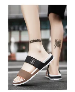 Outdoor shot of men's casual sport sliders with black and brown straps and saw-tooth sole
