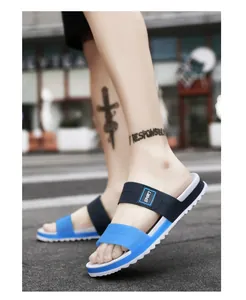 Detailed side view of blue and white sport slippers with non-slip sawtooth sole