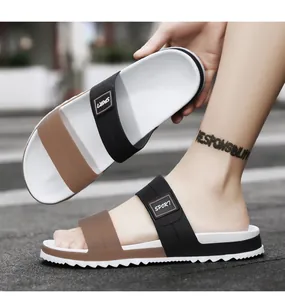 Detail of men's double strap slippers with SPORT logo and non-slip serrated sole