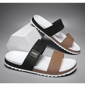 Detail view of sport sandals showing dual black and brown straps with non-slip sawtooth sole