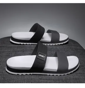 Detail of men's EVA slippers with dual black straps and non-slip serrated sole