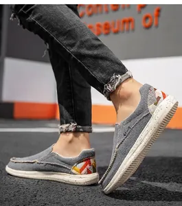 Détail de mocassins en toile grise avec talon à motif ethnique et semelle mouchetée