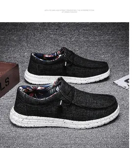 Detail of black canvas loafers showing tropical print lining and ink splatter sole