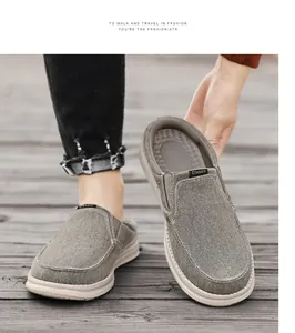 Detail of grey canvas mule loafers showing hand-stitched toe and elastic side band