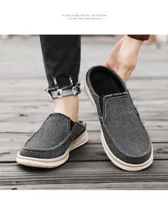 Detail of dark gray canvas mule loafers with textured fabric and elastic side panels