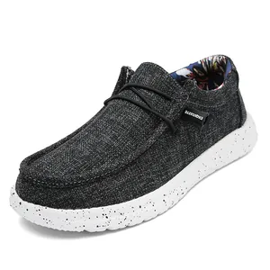 Men's dark gray canvas loafers with speckled white rubber soles and exquisite detailing