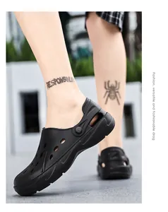 Outdoor low-angle shot of black breathable EVA garden clogs with non-slip sole