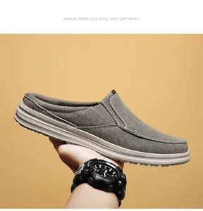 Detailed shot of grey canvas mule sneaker showing thick rubber sole and fabric texture