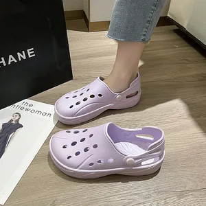 Detail showing the light purple EVA clogs with breathable holes on light wood floor