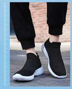 On-foot view of black slip-on sock sneakers featuring breathable knit uppers and white soles