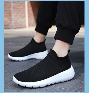 Detail of black knit sock sneakers with flexible breathable mesh and white thick sole