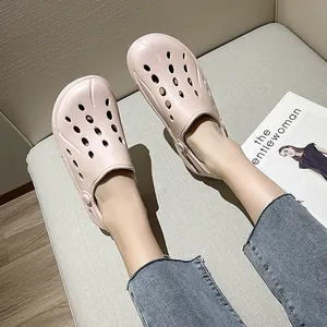 Close-up of light pink breathable EVA clog shoes worn with blue denim jeans in a home setting