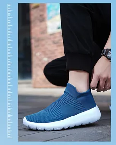 Detail of blue breathable knit slip-on sneaker with thick cushioned white sole for men