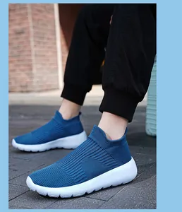 Detail of dark blue knit slip-on sneakers with breathable fabric and white EVA sole