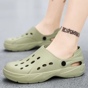 Light olive green EVA clogs on feet featuring breathable holes and ergonomic soft sole