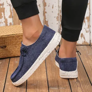 Detail of navy canvas men's loafers with contrast stitching and speckled platform sole