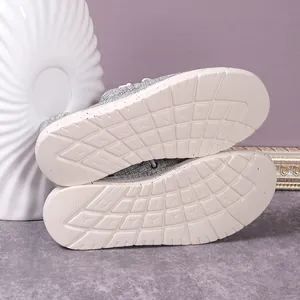 Close-up of durable non-slip rubber soles with grid patterns on gray canvas loafers
