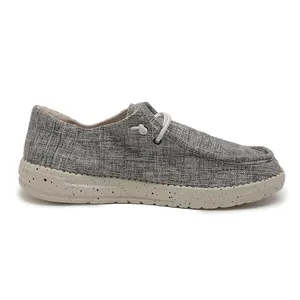 Side view of grey canvas loafers featuring speckled foam sole and elastic laces