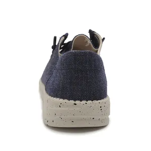 Detail of navy blue woven canvas loafer featuring speckled rubber sole and size 42 label