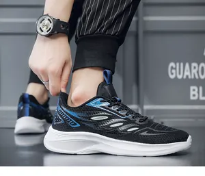 Detail of men's black knit running shoes with blue feather pattern and thick white sole