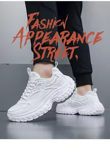 Close-up of white chunky sneakers with breathable mesh panels and thick anti-slip soles