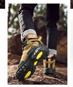 Low-angle outdoor view of khaki men's hiking boots with non-slip thick rubber soles