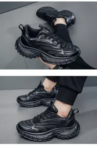 Detail of chunky black sneakers with breathable mesh upper and durable thick rubber sole