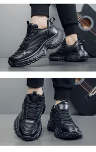 Detail view of black chunky dad sneakers showing mixed mesh material and thick anti-slip sole