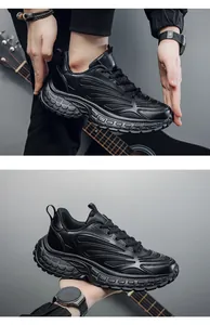 Detail of all-black chunky sneakers featuring leather mesh texture and thick rubber soles
