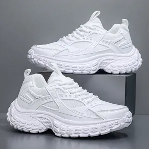 All-white chunky sneakers with mesh panels and thick rubber soles for casual wear