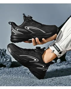 Detail of all-black athletic shoe with silver stripes and rotary dial lacing system