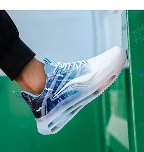 Detail view of the white athletic shoe featuring a thick air cushion sole and mesh fabric
